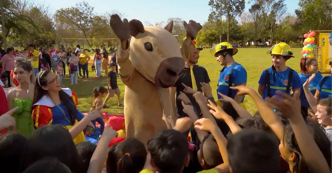 Children at outdoor event with costumed characters and entertainers, MEGA USA family celebration