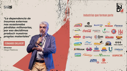 Businessman giving presentation with Mega Plásticos and top industrial brands' logos at event.