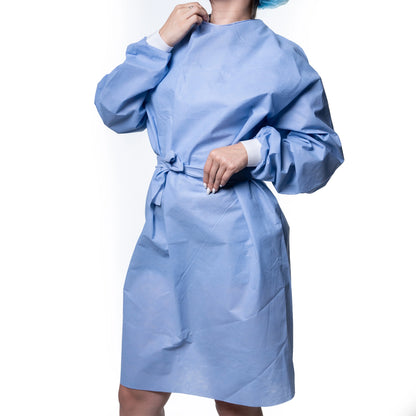 Person wearing a light blue disposable hospital gown with white cuffs, medical supply product.