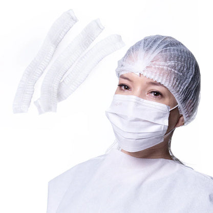 Nurse wearing disposable bouffant cap, face mask, and gown with extra caps, hospital supplies